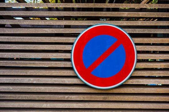 No parking sign on wooden fence