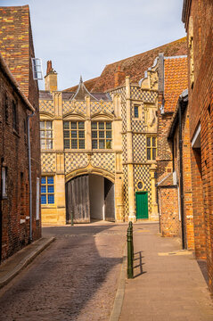 A view from College Lane looking towards the historic Trinity Guildhall in King's Lynn, Norfolk, England in summertime