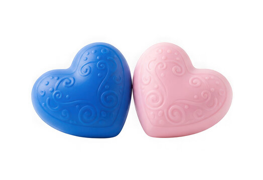 Two decorative heartshaped objects in blue and pink with embossed swirl patterns isolated on transparent background