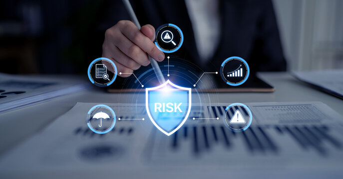 A business professional engages in financial analysis with focus on risk assessment, highlighted by charts and digital icons in a modern office setting. Nascent