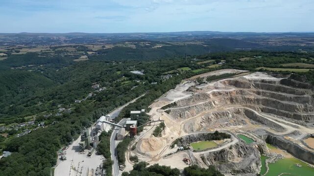 Hingston Down, Cornwall, England: DRONE VIEWS: The drone circles around and behind the granite quarry showing both the stepped quarrying technique and the pools of water mineralised with Arthurite.