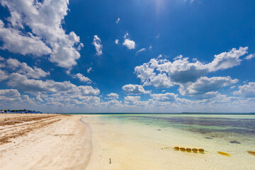 Tropical sandy beach and an exotic view of the Atlantic Ocean against a blue sky with clouds in Cuba, Caribbean – background for projects, wallpaper © anettastar
