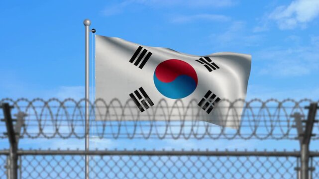 South Korean flag waving behind barbed wire fence
