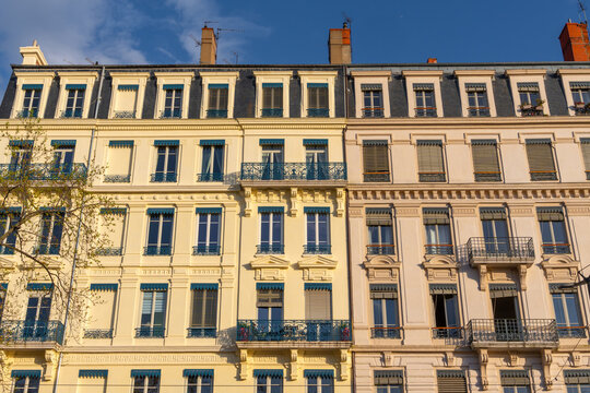 Classic European apartment buildings with ornate balconies and mansard roofs. Lyon
