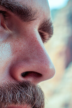 A close-up shot of a man with a thick beard. vertical frame