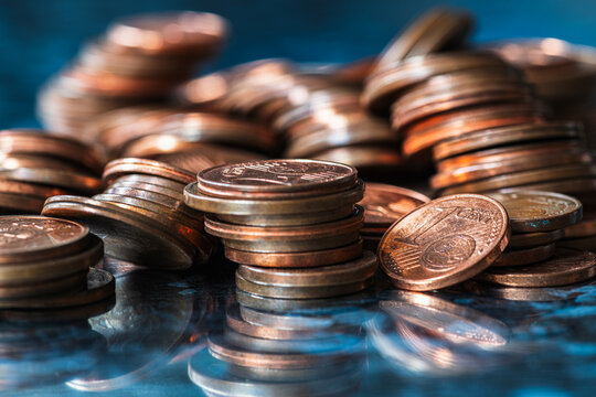 Stacks of Copper Cent Coins on a Metal Surface