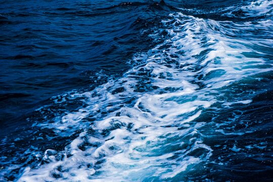 Ocean wake with white foam trailing