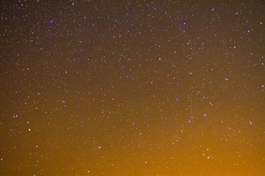 Vast starry night sky with distant glowing orbs