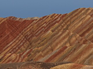 Colorful Zhangye Danxia mountains in Gansu, China, featuring layered rainbow rock formations, dramatic desert scenery and striking geology in a famous Danxia geopark. © JEREMIE