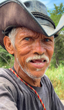 Elderly cowboy with blue eyes looking at camera