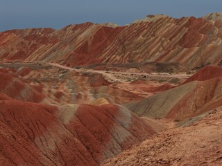 Colorful Zhangye Danxia mountains in Gansu, China, featuring layered rainbow rock formations, dramatic desert scenery and striking geology in a famous Danxia geopark. © JEREMIE