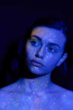 Futuristic beauty in chic attire illuminated by vibrant neon lights