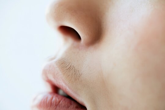 Macro side view of visible hair above a woman&rsquo;s upper lip, representing unwanted facial hair, hormonal changes and cosmetic hair removal concerns in women