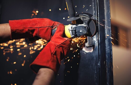 Process of using a grinding tool to cut metal with sparks flying in an industrial setting showcasing technical skill and precision
