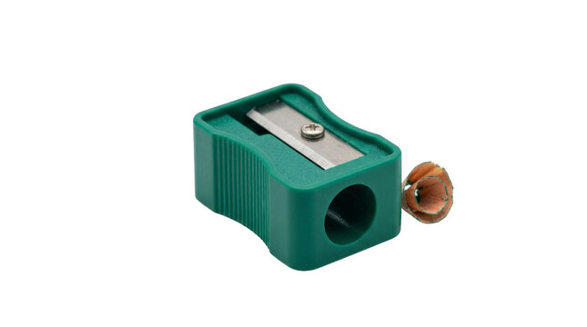 Green plastic pencil sharpener with metal blade and wood shavings on white background