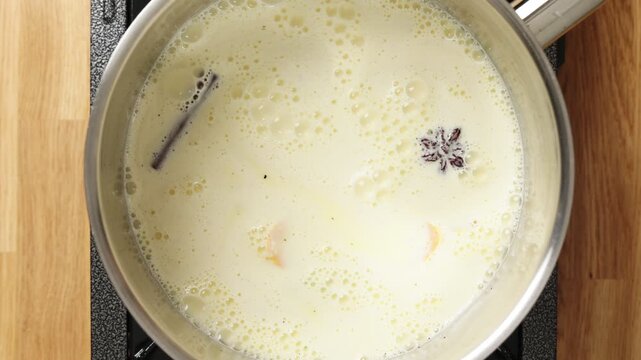 Prepared mixture pours into saucepan for thickening. Gentle stovetop heat turns dessert base into smooth custard. Make-ahead base saves time for pastry cream, pudding, tart filling or cafe service.
