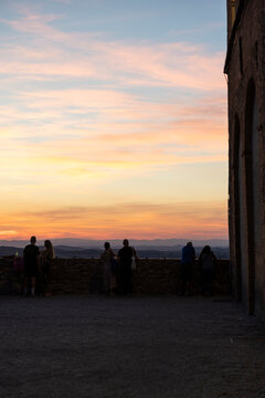 people observing sunset in Tuscany italy