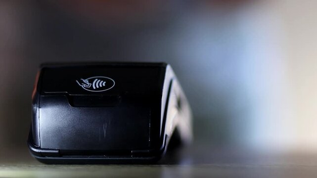 Contactless payment using a credit card on a pos terminal for a secure and fast digital transaction at a store checkout counter