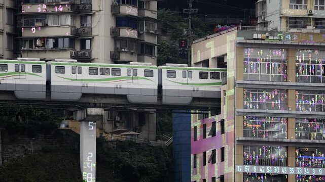 train enters liziba station inside a building on bridge in Chongqing china