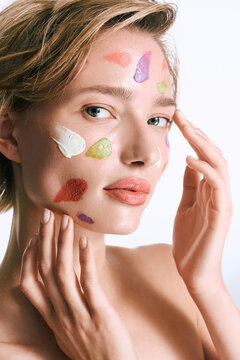 Portrait of a woman showcasing youthful beauty and with various skin care swatches