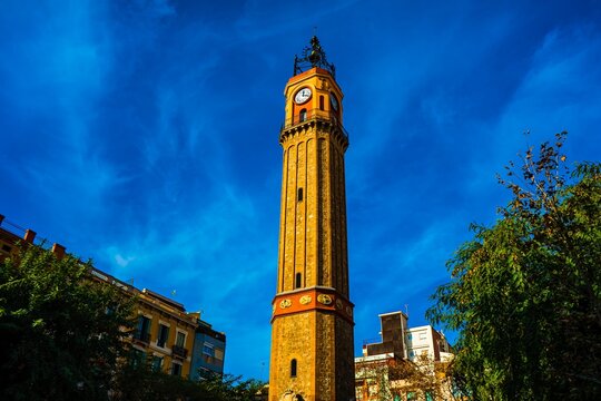 Tall clock tower against a bright blue sky