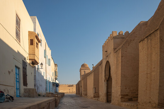 Alley running along the side of the Great Mosque of Kairouan in the medina, in Kairouan, Tunisia
