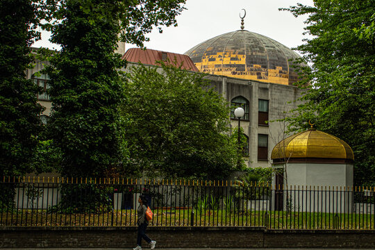 London, England, UK &ndash; London Central Mosque with its golden dome and minaret, viewed through surrounding trees.