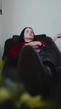 Young woman receiving hypnosis during a therapy session