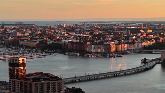 Scenic drone shot of Helsinki cityscape skyline at sunset, Finland
