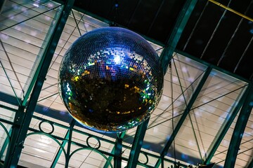 Disco ball hanging in a venue with glass ceiling © Novanture