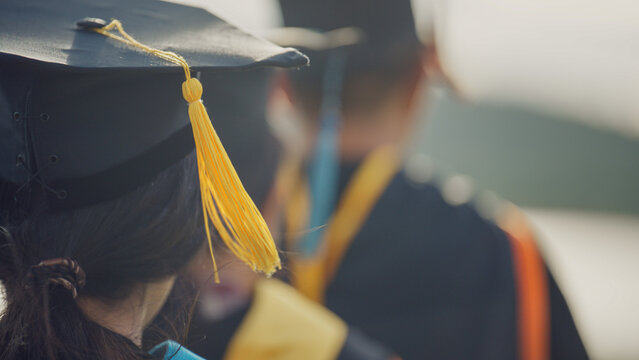 Graduates Raising Graduation Caps and Diplomas in Celebration