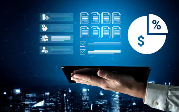 A hand holds a tablet displaying various digital analytics and financial reporting graphics against a city skyline at night, symbolizing modern business solutions and data-driven decisions. Ledger
