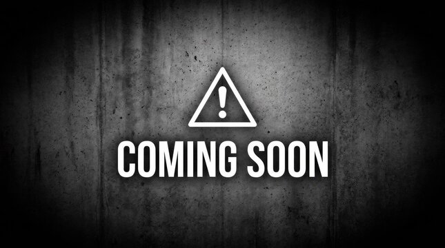 Coming soon text on dark grunge textured wall.