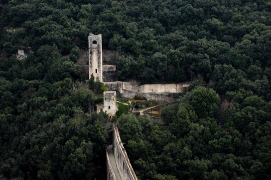SPOLETO, ITALY - FEBRUARY 7, 2017: Fortilizio dei Mulini and Ponte delle Torri. The latter is a massive stone aqueduct and bridge, the former, a small fort that used water to run old grain mills