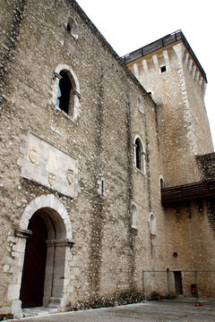 SPOLETO, ITALY - FEBRUARY 7, 2017: Entrance to the Cortile d'Onore (Honor Courtyard) of the Rocca Albornoziana. A double-decker portico adorned with papal coats of arms and hexagonal water well