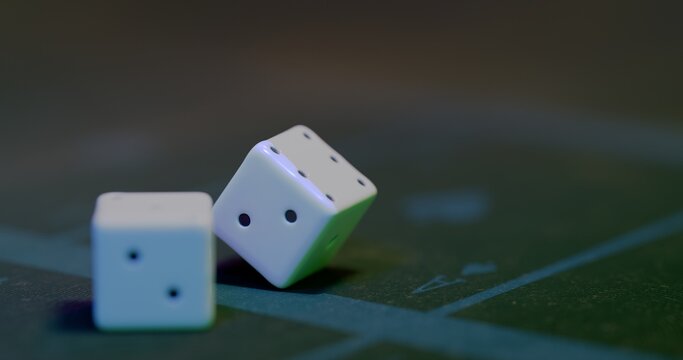 Dice rest on card table surface with focus on faces