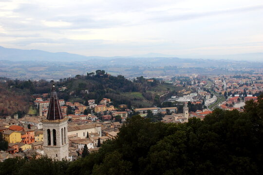 Pristine view from Spoleto with church towers, human settlements, buildings, river, bridges, roads, cars, thickets, hills, as far as the eye can see, with distant mountains and a soothing sky