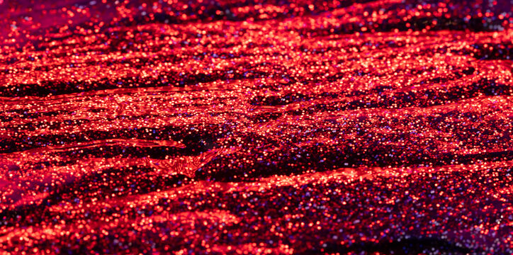Red glitter cosmetic texture with sparkling makeup pigment and glossy abstract brush strokes. 