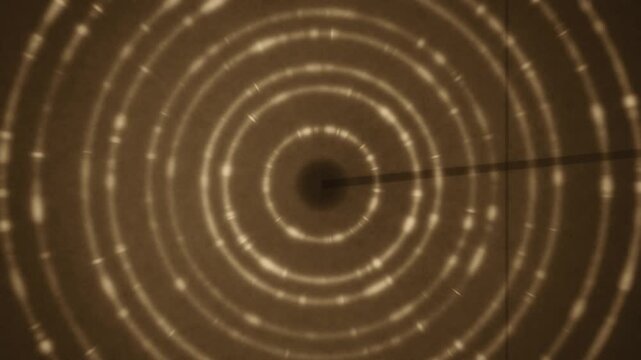 X-ray powder diffraction Debye rings rotating crystal grain texture dark detector seamless loop in soft brown tones
