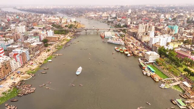 Aerial drone view of Sadarghat river port with passenger boats and dense Dhaka city