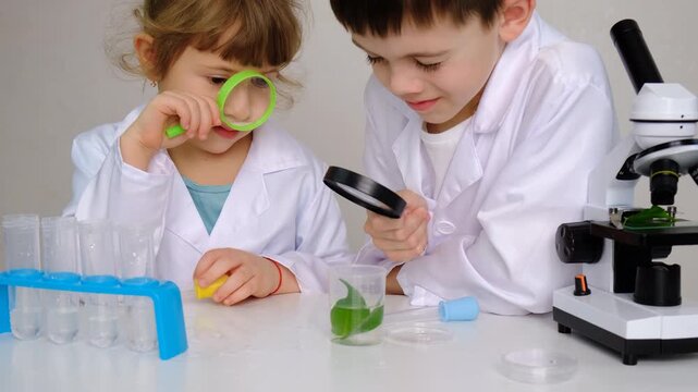 Laboratory examination of a child with test tubes, reagents and a microscope. Selective focus.