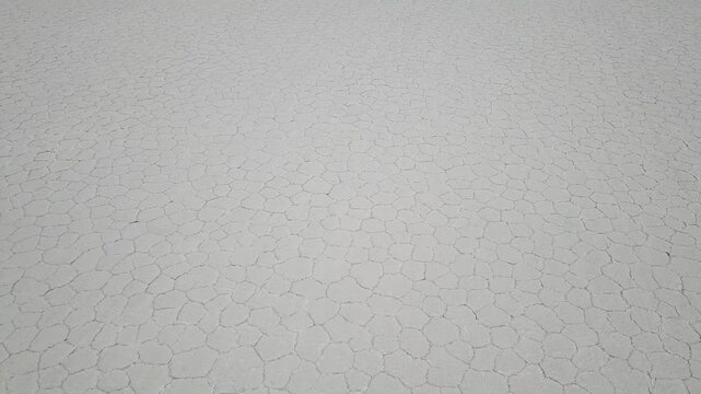 Cinematic Top-Down drone reveal of a Yellow camper truck parked at Salar de Uyuni - Uyuni Salt flats desert