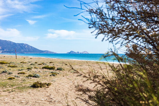 Coastal view of mediterranean beach with distant islands
