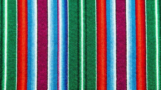 A detailed close up of a traditional Mexican woven fabric featuring a repeating pattern of vibrant, colorful vertical stripes in various shades.