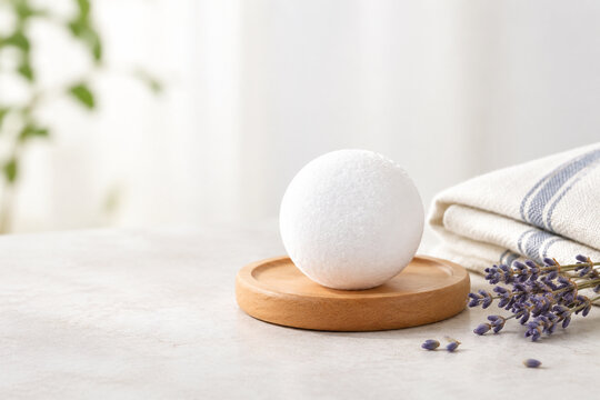 Camphor ball on wooden coaster with cotton cloth and dried lavender