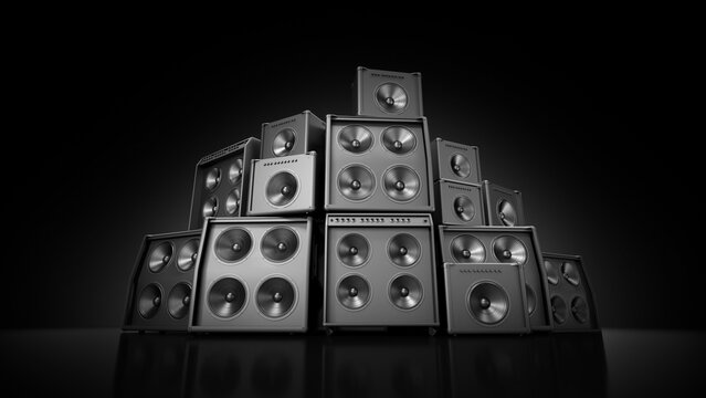 Stacked amplifiers arranged in a pyramid on a reflective black surface, with visible speaker cones and metal grilles under studio lighting.