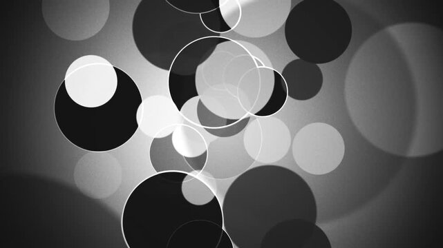 Abstract black and white background with gently moving circles and rings with soft gradients and grainy texture. Ideal for monochrome visuals and minimalist projects. Full HD looping animation.