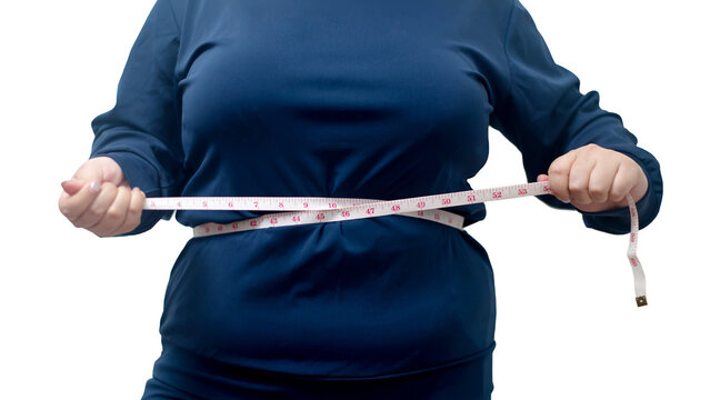 Plus-Size Woman Measuring Her Body with a Measuring Tape While Wearing Weight-Loss Shapewear