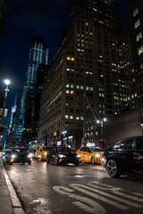 Busy New York City street with yellow taxis and traffic at night © Jorge Orro