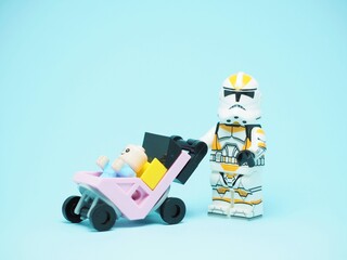 Fototapeta premium Indonesia - October 3, 2023 : Mini toy of action figure with blurred background. Parent with baby concept design.